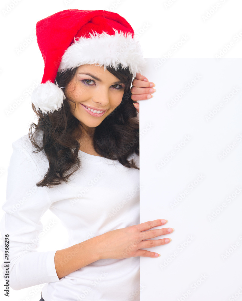 Beautiful christmas woman in santa hat holding empty board Beautiful christmas woman in santa hat holding empty board