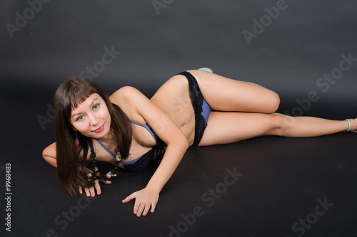 studio lying portrait of a brunette in underwear
