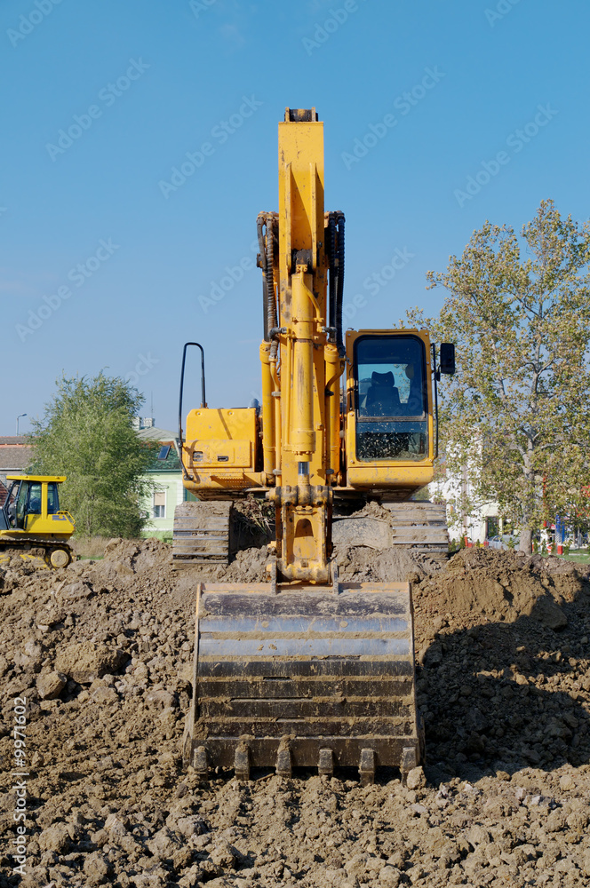 Working  with excavator on yellow  ground