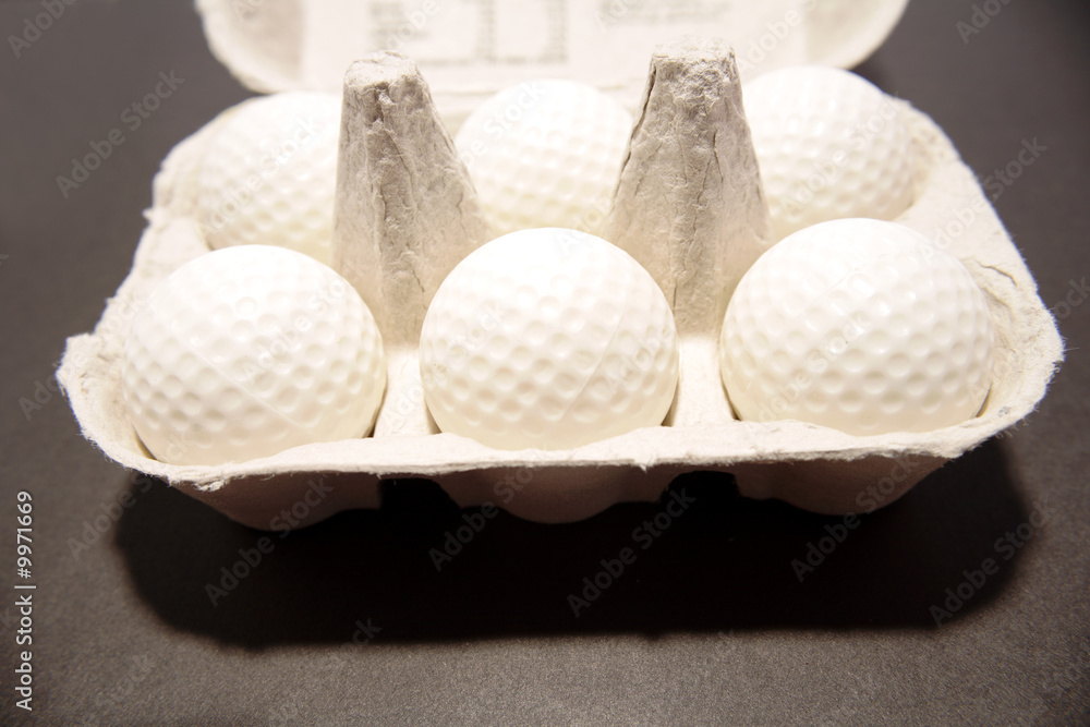 Golf balls inside egg carton Stock Photo | Adobe Stock