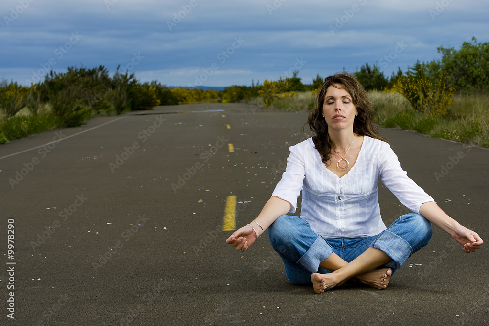 Woman Meditating in the Road