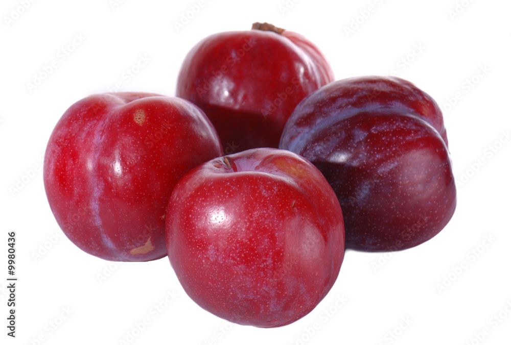 Red plums isolated on white background