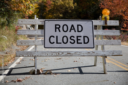 Road Closed sign with concrete barricade