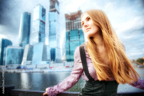 Young woman on modern city background. HDR image. © chaossart