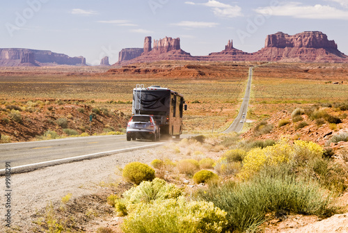 Slika na platnu Recreational vehicle driving through Monument Valley