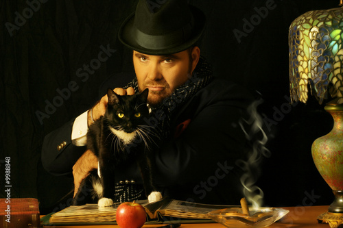 Quadro su tela sinister man sitting at a table with a black cat