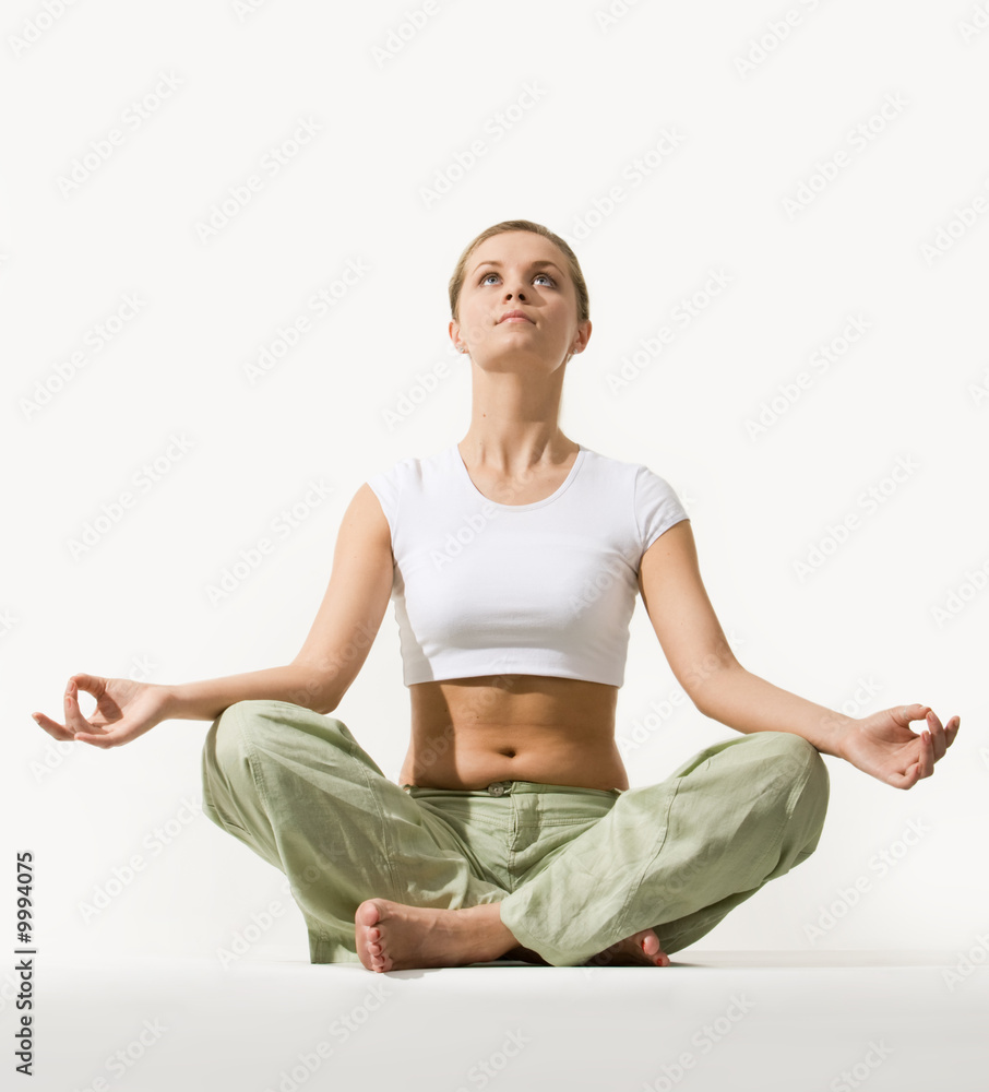 Image of young pretty woman sitting in pose of lotus Image of young pretty woman sitting in pose of lotus