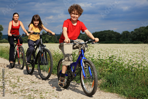 Family riding bikes in rural scenery