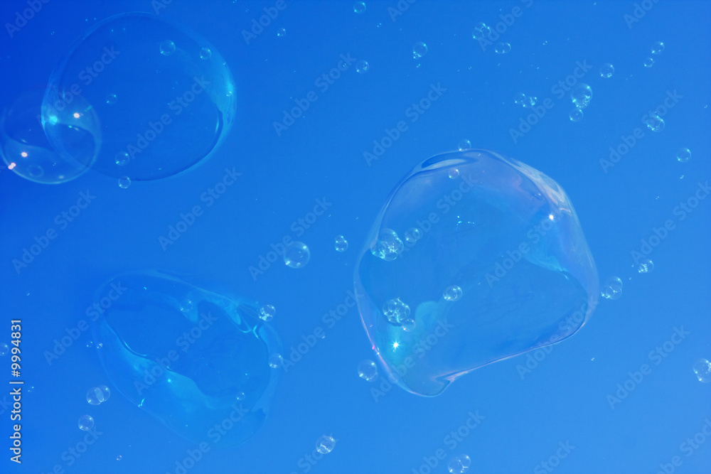 Soap bubbles on the blue sky background