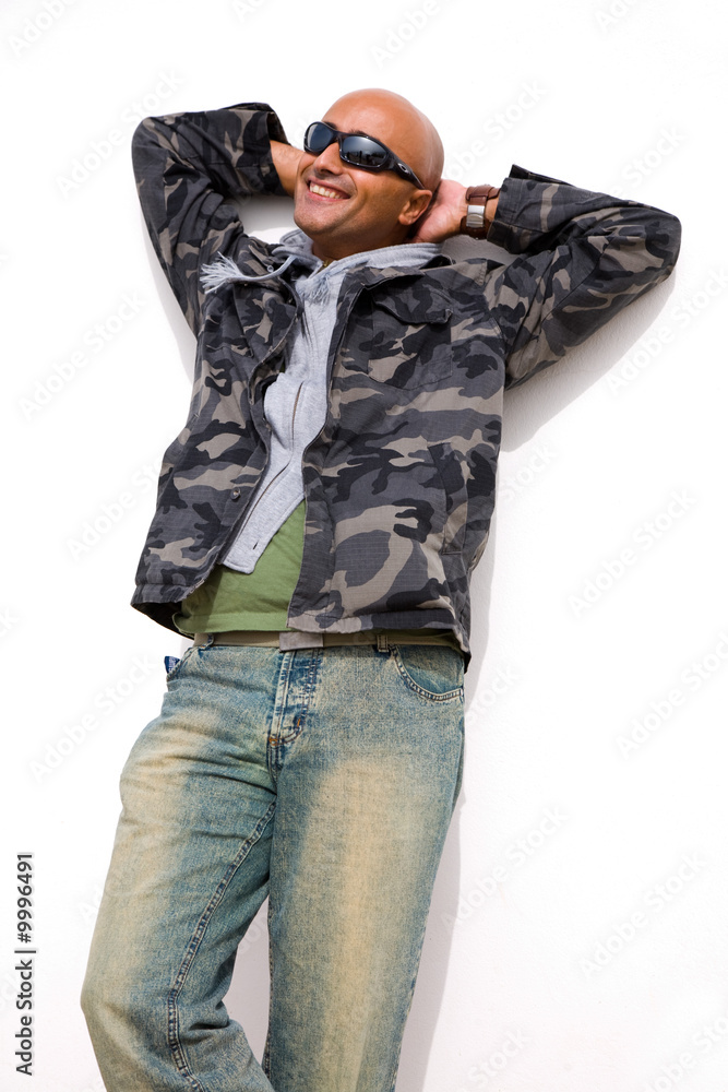 young casual man with as white wall as background young casual man with as white wall as background