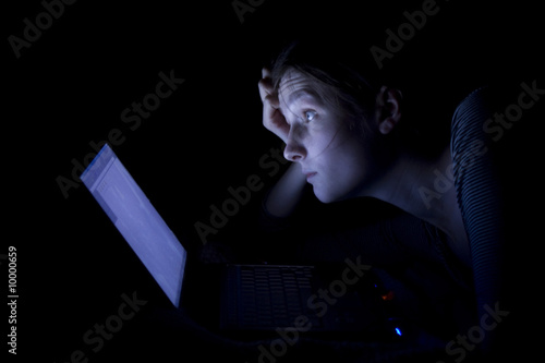 Konstfotografi Young woman with laptop at night.