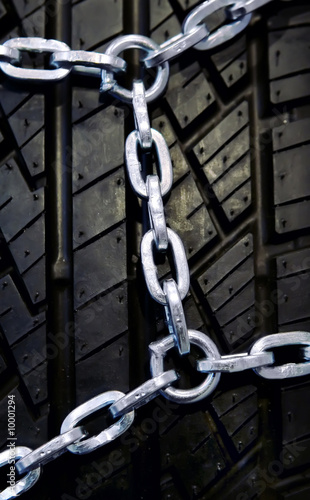 Background of black winter tyre with chain photo