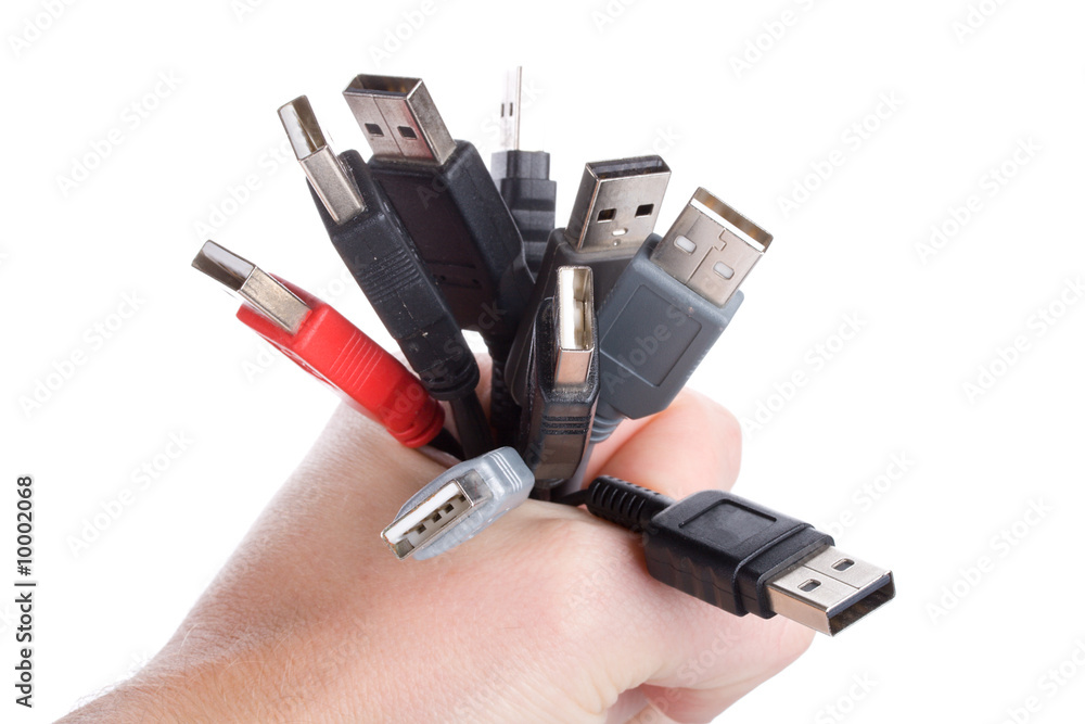 many usb cables in hand, isolated on white many usb cables in hand, isolated on white