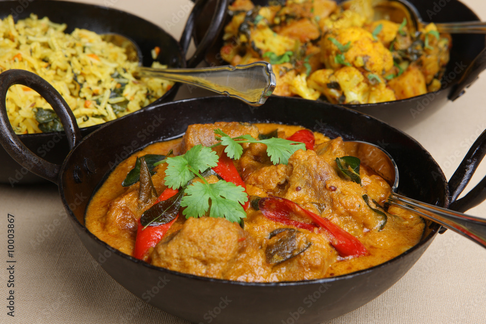 Lamb korma with pilau rice and vegetable curry