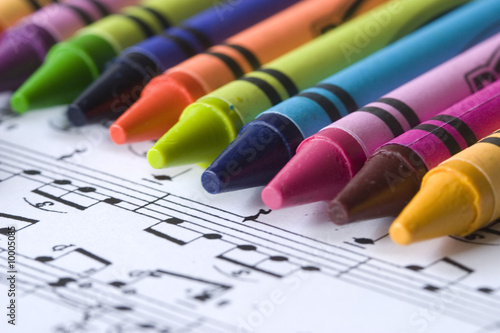 A child's crayons and music score