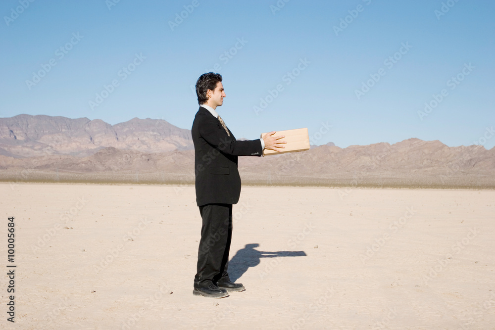 Businessman giving a box