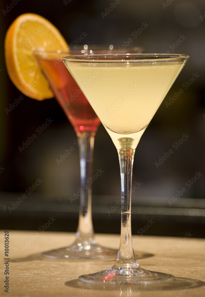 A margerita and cosmopolitan Cocktail drink on a bar top.