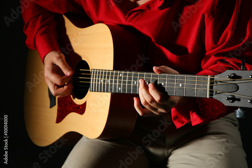 Close-up hands with guitar
