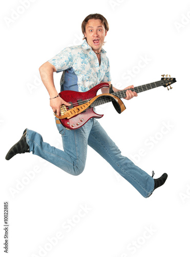 Young man with guitar jumping