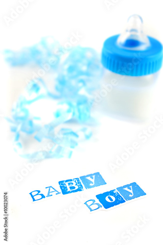 a blue baby bottle with milk and celebratory ribbon