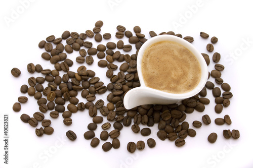 Cup of espresso and coffee beans isolated on white