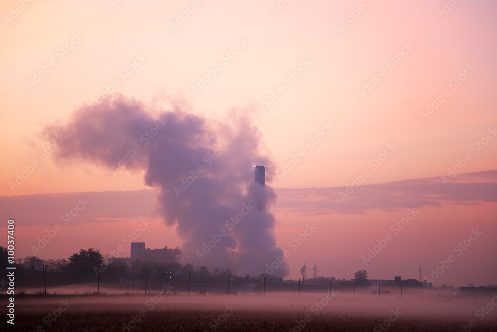 Fototapeta premium Smoking Chimney during sunrise
