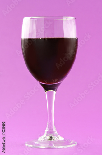 glass of red wine, pink background