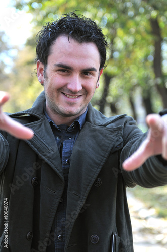 Handsome young man outside in nature photo