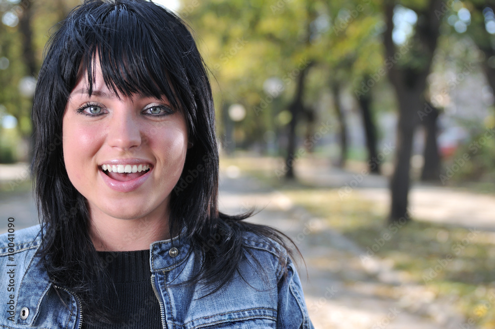 Happy young woman smiling outside in nature Happy young woman smiling outside in nature