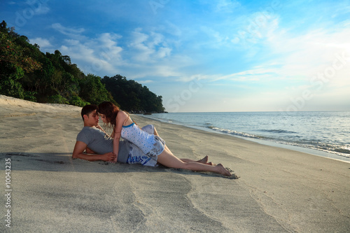 young romantic couple making out on secluded beach