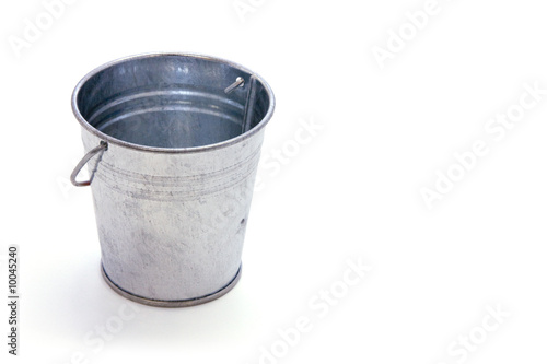 Galvanized metal bucket with shadow on white field