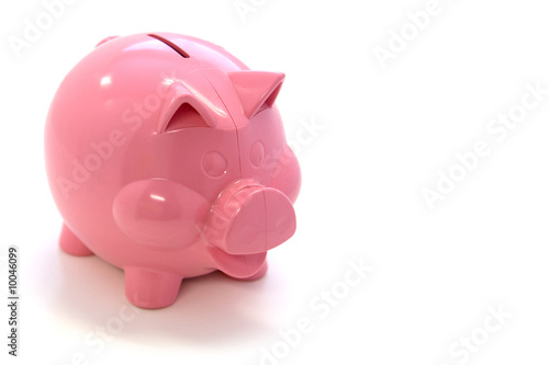Happy pink plastic piggy bank over white background