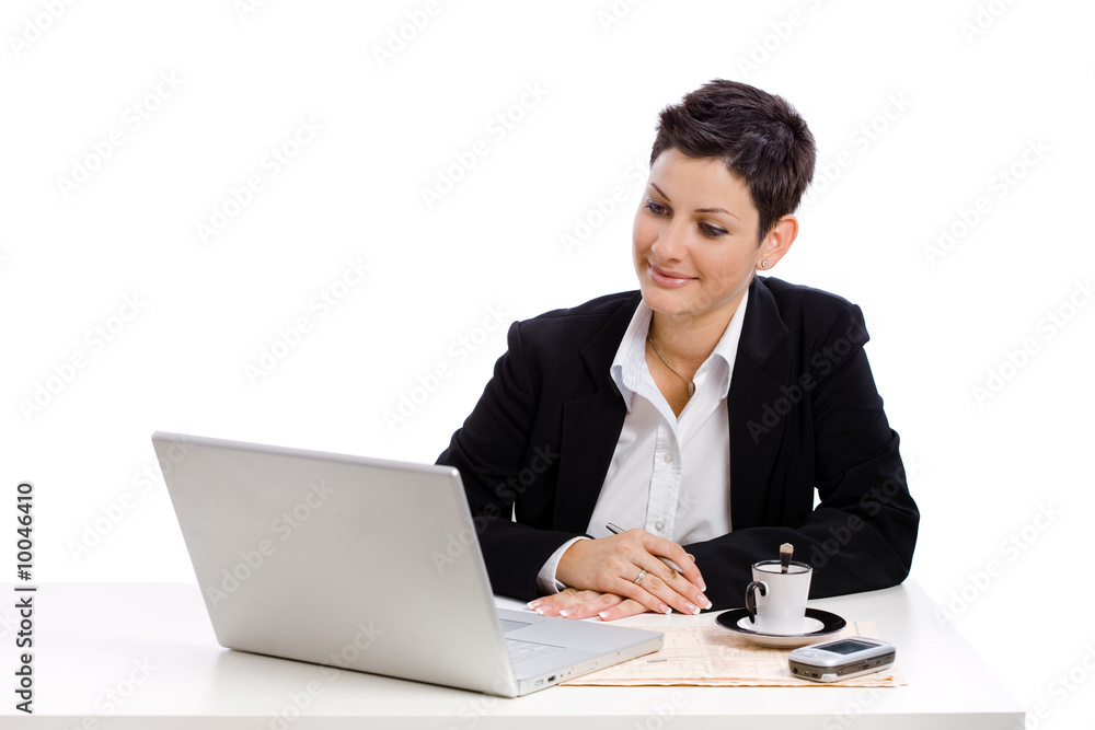 Businesswoman working at desk, isolated on white. Businesswoman working at desk, isolated on white.
