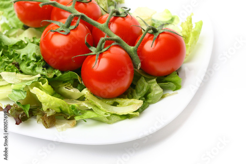 salad and cherry tomatoes isolated on white background