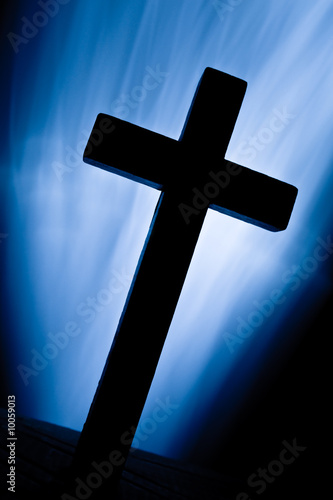 Silhouette of wooden christian cross over luminosity beans