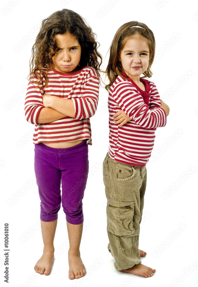 two little girls back to back in quarrel isolated on white two little girls back to back in quarrel isolated on white