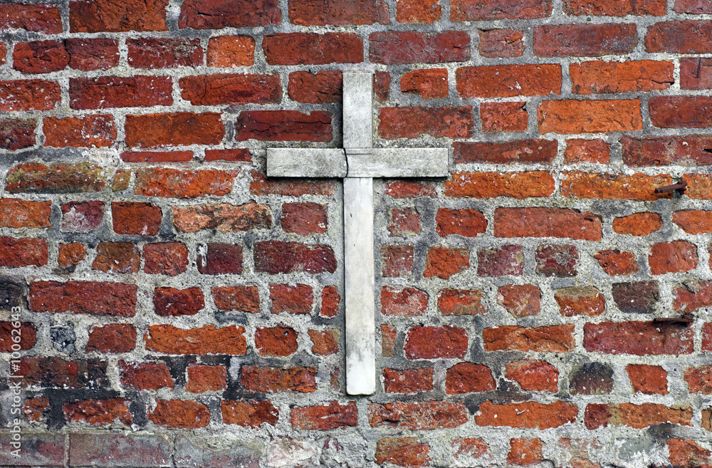 White cross on red church brick wall