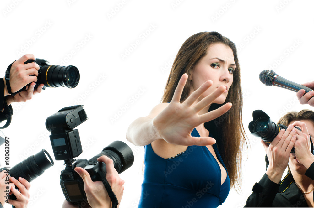 Photographers are taking a picture of a film star Photographers are taking a picture of a film star