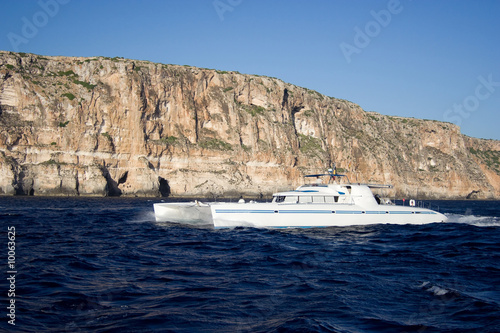 The motor catamaran cruise on the sea.