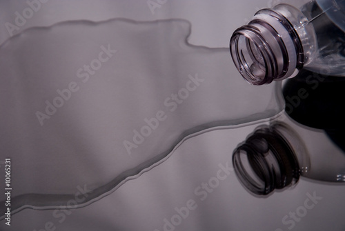 View of reflected , spilled water bottle.