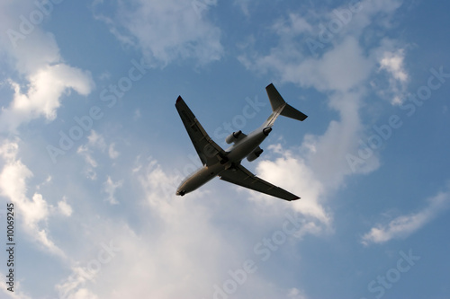 Silhouette of airplane in blue sky
