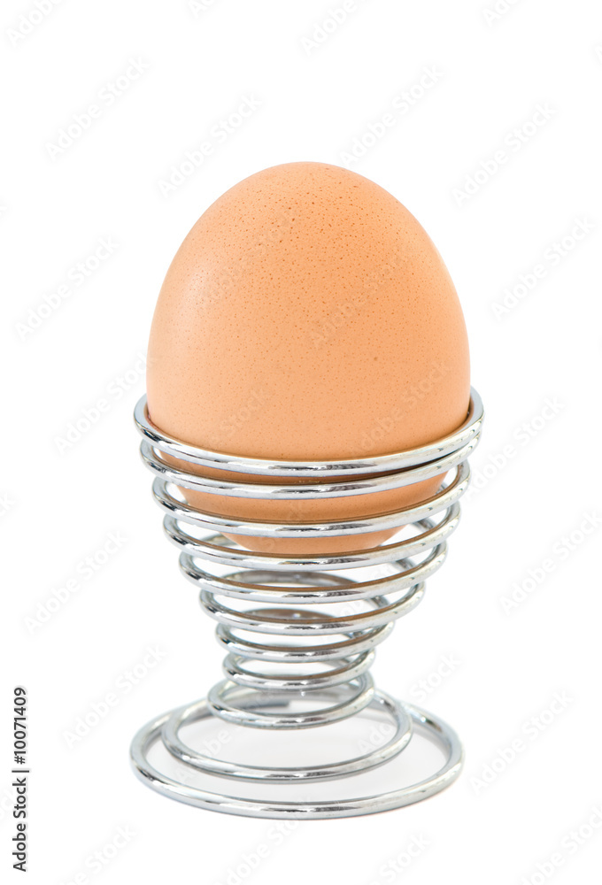Boiled egg isolated on white in chrome egg cup Boiled egg isolated on white in chrome egg cup