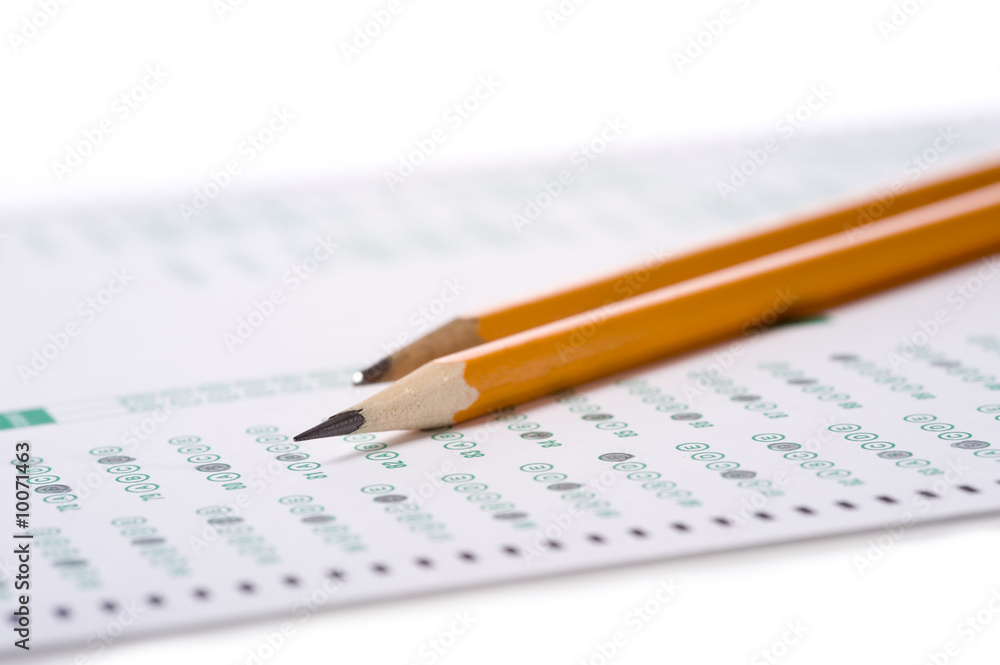 A yellow pencil on a computer read examination or test A yellow pencil on a computer read examination or test