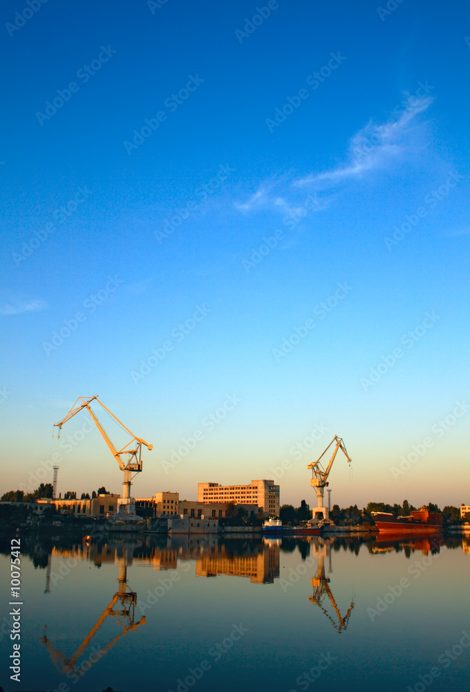 Wide-angle photo of cranes in a shipbuilding plant