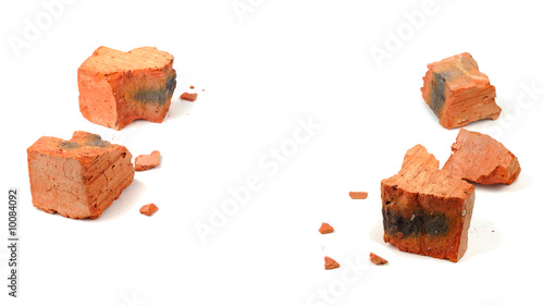 Fragments of shattered brick isolated over white