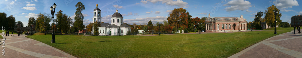 panorama of old church in autumn park at sunny day