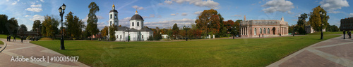 panorama of old church in autumn park at sunny day