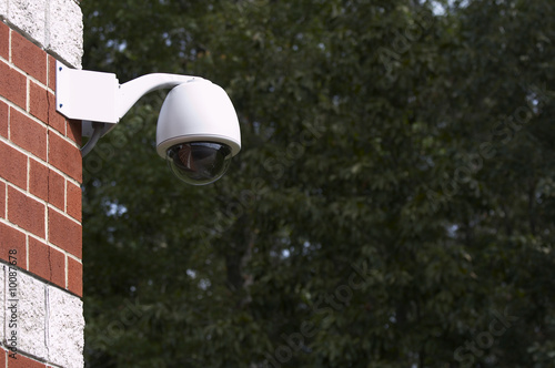 a picture of a surveillance camera on a brick wall