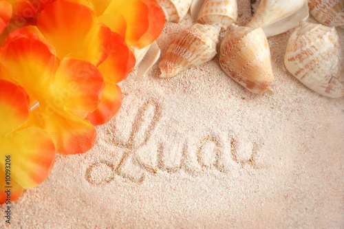 hawaiian beach background with words luau on  tropical sand photo