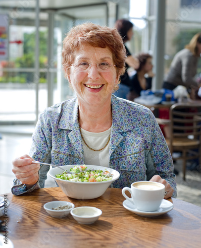 senior women having salad and coffee in a coffee shop